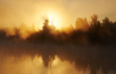 River and solar fog. Early morning with sunrise. Backlighting