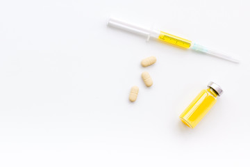 Fototapeta premium Medical therapy. Syringe, bottle with drug, pills on white background top view copy space