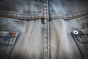 macro texture shabby blue denim with yellow stitched thread