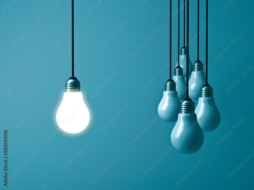 Aufkleber one hanging light bulb glowing and standing out from unlit bulbs on dark green pastel color backgrou