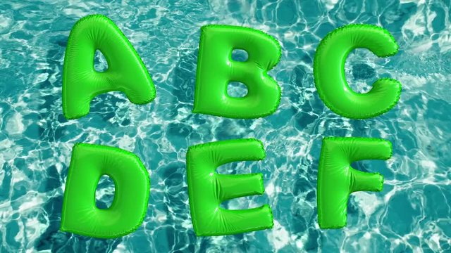 alphabet made of shaped inflatable swim ring floating in a refreshing blue swimming pool