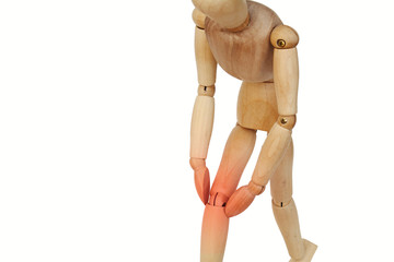 Wooden human with knee pain.