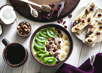 Yogurt with different fruits on a wooden background. Useful food, diet, organic.