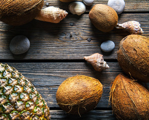 4059220 Composition of fresh pineapple and coconuts on wooden background