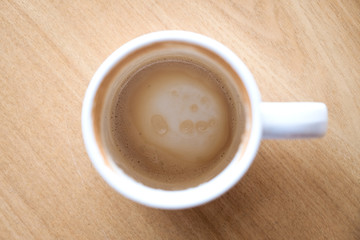 Top view image of finished cup of coffee on wooden table in cafe