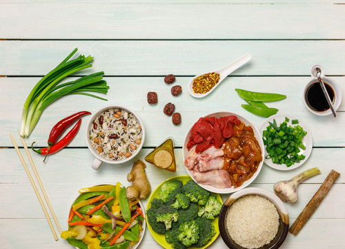 Chinese food background, raw ingredients, meat, vegetables, rice, beans, nuts and spicies on old light blue wooden table. Healthy food, clean eatind and diet concept, Top view, overhead, flat lay