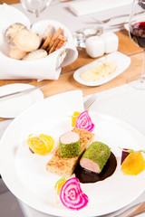 Roast pork tenderloin with crispy potato bread, marinated beetroots and green pepper sauce served in a restaurant