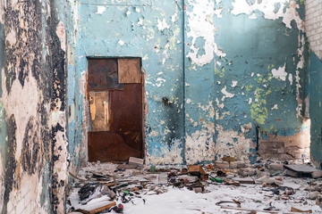 Closed door in a dirty ruined room