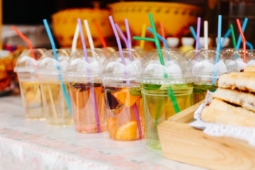 Hot fruit tea or fruit water in glasses with tubes.