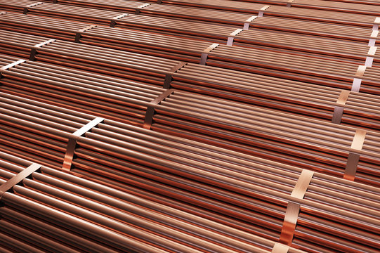 Stack of copper pipes in warehouse. Rolled metal products. 