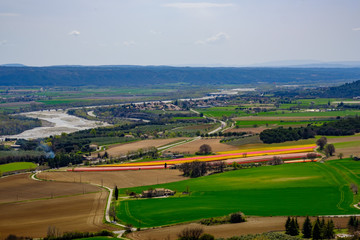 Fototapeta na wymiar Vue panoramique depuis le village de Lurs (Alpes-de-Haute-Provence) au printemps sur la vallée de la Durance, le plateau de Valensole, les champs de tulipes. 
