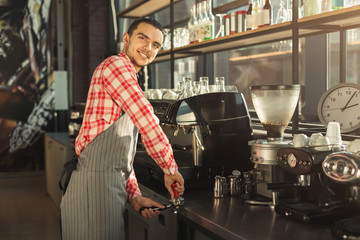 Barman making coffee in professional coffee machine