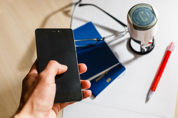 Hands working on digital device network graphic overlay