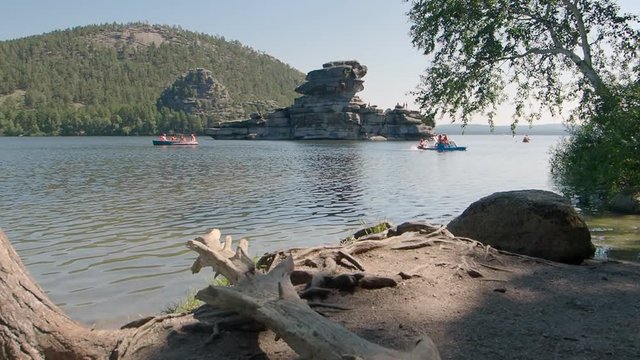 Families enjoying leisure water sports on Lake Borovoe in Kazakhstan