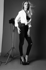 beautiful girl with blond hair in elegant clothes posing in studio