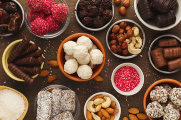 Wooden desktop with assortment of healthy sweets and nuts
