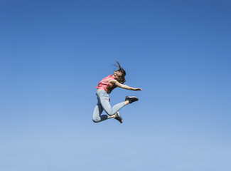 Fototapeta na wymiar girl jumping on the sky background