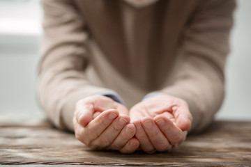 Empty nest syndrome. Selective focus of an elderly mans hands while being shown to you
