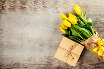 Yellow tulips on wooden background