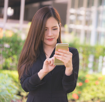 Office woman is texting using mobile phont