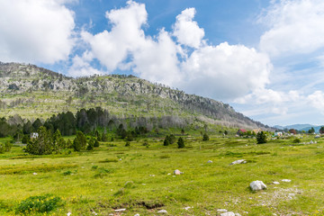 Fototapeta premium A small village is situated among many hills and mountains.