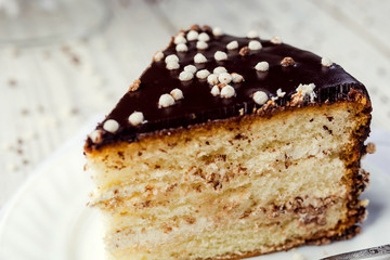 biscuit cake with caramel and chocolate on a wooden background
