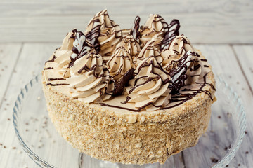 sponge cake with cream decorated by meringue and chocolate