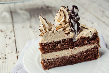 sponge cake with cream decorated by meringue and chocolate