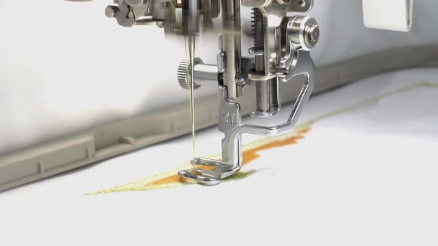 Sewing machine embroider a pattern on the fabric close-up. HD video