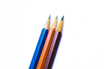Close-up on colorful multicolored sharp pencils. Isolated over white background. Top view