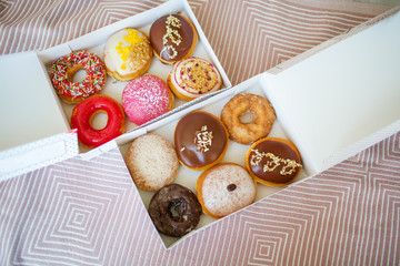 Colorful sweet donuts in box