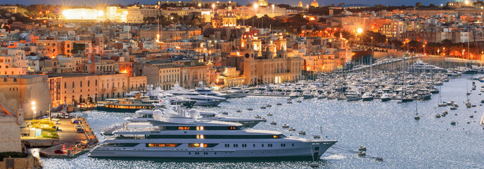 Valletta, Malta. View of Grand harbor from Upper Barrakka Gardens in the evening