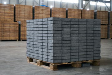 Close-up of a Concrete road curbs at the factory for the production of cement products, paving slabs. Industry manufacturing concept