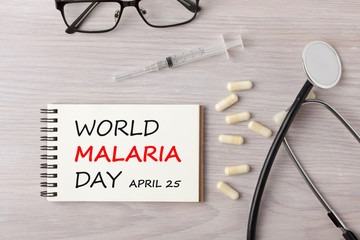 World Malaria Day written on notebook concept