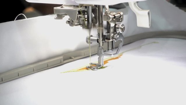 4K view of sewing machine embroider a pattern on the fabric close-up. 