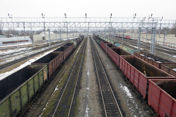 Fototapeta na wymiar Railway station in winter and freight trains