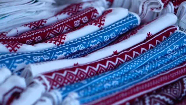 A symbol of Ukraine, national Ukrainian rushnyk. Traditional ethnic towel with hand embroidered cross stitch ornament pattern. White cloth with multicolor needlework texture, close-up. 