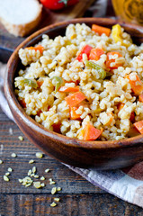 Porridge from bulgur with vegetables: carrots, bell peppers, onions, zucchini