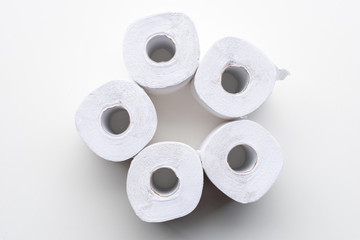 Directly above view of white recycled toilet paper rolls arranged on white background