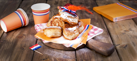 Traditional Dutch sweet pastries. Feast day of the King. Decor. Orange things for the holiday. Netherlands. Paper utensils for a picnic and a holiday