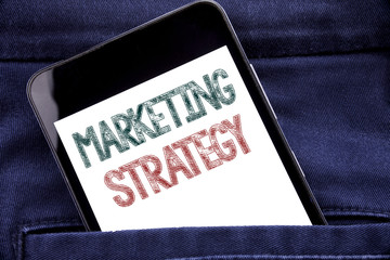 Handwriting Announcement text showing Marketing Strategy. Business concept for Success Digital Plan Written phone mobile phone, cellphone placed in the man front jeans pocket.