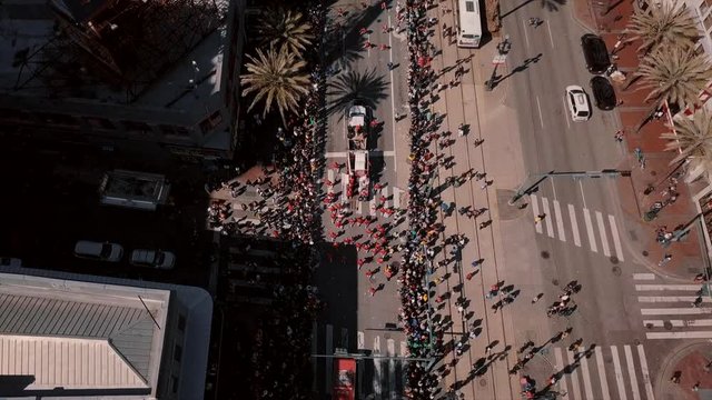 Drone shot flying through downtown New Orleans over Parade.