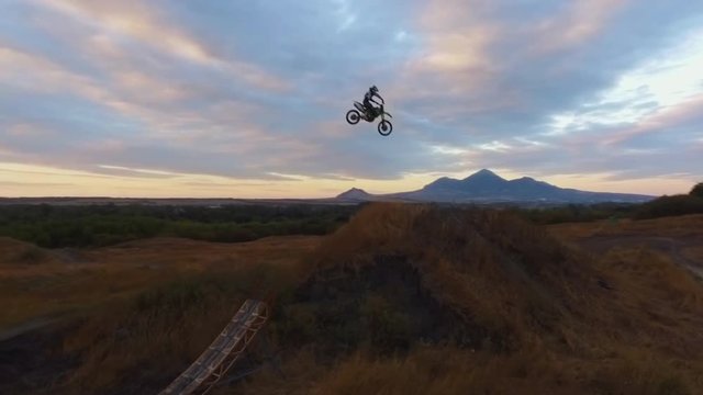 Extreme Freestyle Motocross Jumping on ramp aerial view 4k