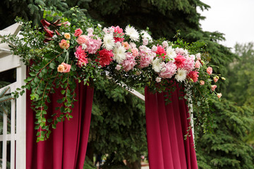 Wedding arch for wedding ceremony. Beautiful marsala wedding decor and decoration with fresh flowers