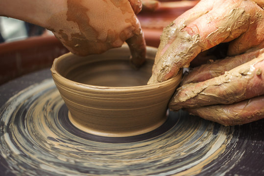 hand maid, molding from clay, making dishes.