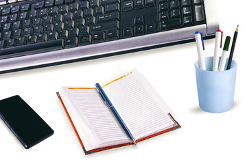 Work place with computer keyboard, smartphone, diary, pen, pencil cup on. Isolated.