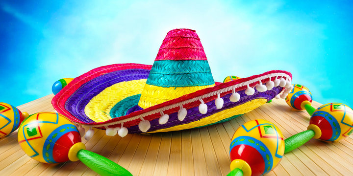 Mexico.Colored sombrero and maracas on a wooden background.	
