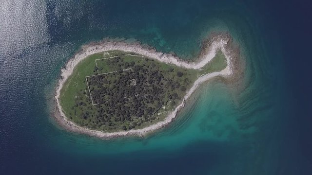 Top aerial view of small desert fish shaped island Gaz in Brijuni islands, Istria, Croatia. Original untouched LOG format.