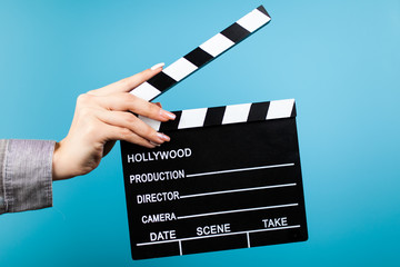 Female hands holding a clapperboard