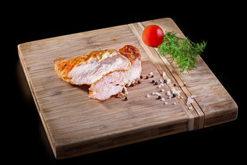 grilled chicken breasts on wooden cutting board